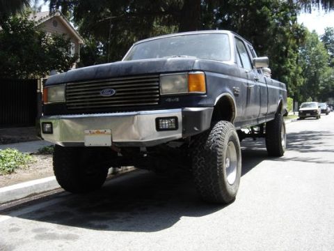 1987 Ford F-250 - This 1987 Ford F-250 pickup truck is viewed from a low, three-quarter front angle on a sunny day.