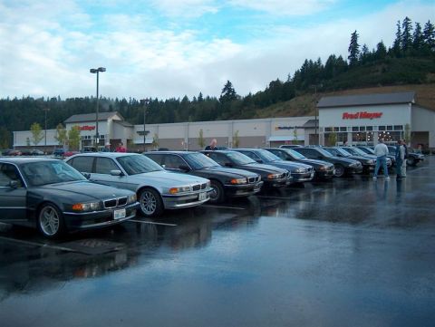 1999 BMW 7 Series - A row of BMW 7 Series sedans are parked in a lot outside a Fred Meyer store.