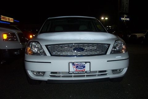 1993 Ford Taurus - Front view of a white 2006 Ford Five Hundred sedan parked at a dealership at night.