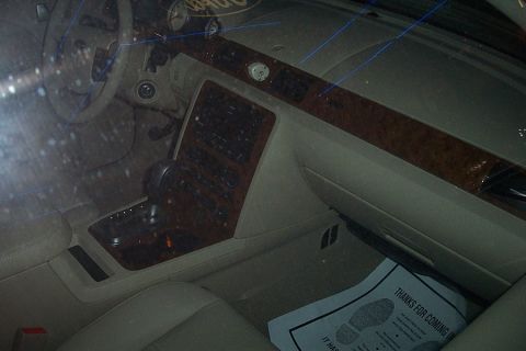 1993 Ford Taurus - The interior of a car shows wood trim accents and the center console with the gear shifter.
