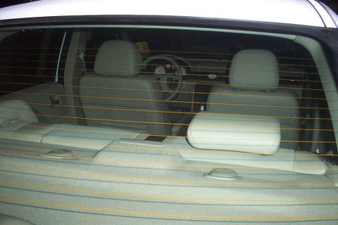 1993 Ford Taurus - The interior of a white car, viewed from the rear, shows light gray seats and dashboard details.