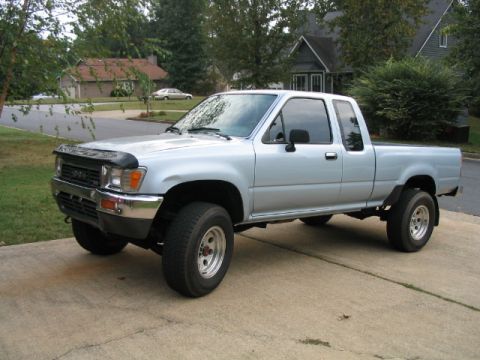 1986 Ford F-150 - This silver pickup truck is shown from a 3q front angle, with the Supermotors.net logo visible at the bottom right.