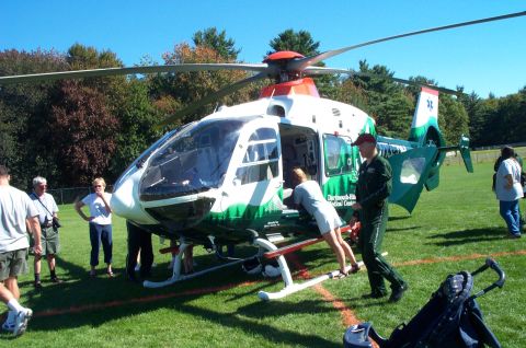 1991 Ford LTD Crown Victoria - A medical helicopter is on display with people gathered around, some boarding the aircraft.