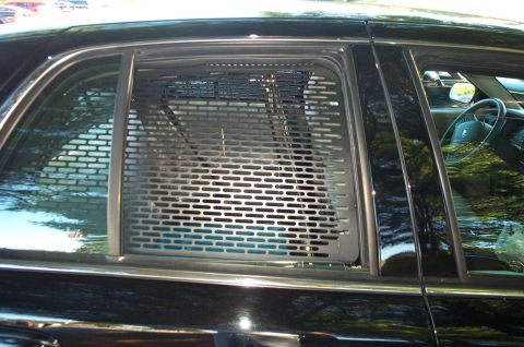 1991 Ford LTD Crown Victoria - Rear passenger door of a 1991 Ford Crown Victoria LTD, showing a security window guard.