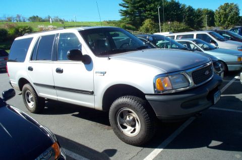 1991 Ford LTD Crown Victoria - This silver SUV is parked in a lot with other vehicles visible.