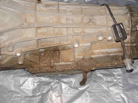 1988 Ford Bronco - A transmission part with an attached electronic device is shown.