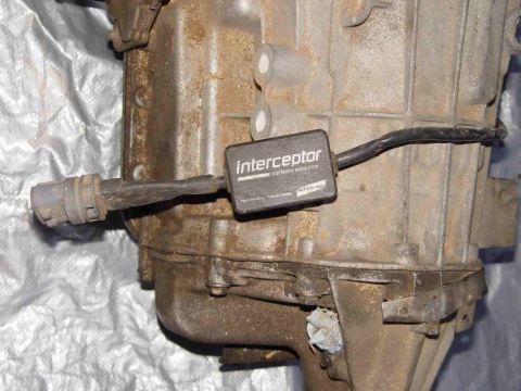 1988 Ford Bronco - Close-up of an Interceptor electronic modulation device attached to a transmission housing.