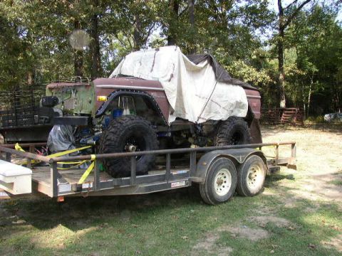 1995 Ford Bronco - A 1978 Ford Bronco, modified with large tires, is loaded onto a trailer.
