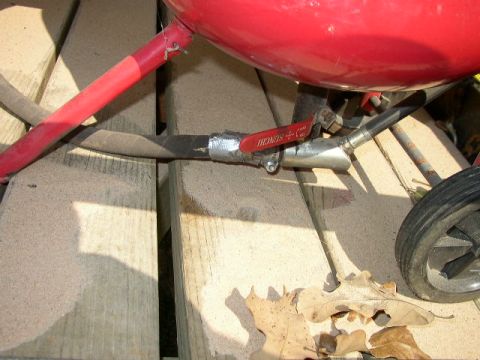 1995 Ford Bronco - Close-up of a red sandblaster tank showing a valve and hose connection, with visible text on the valve.