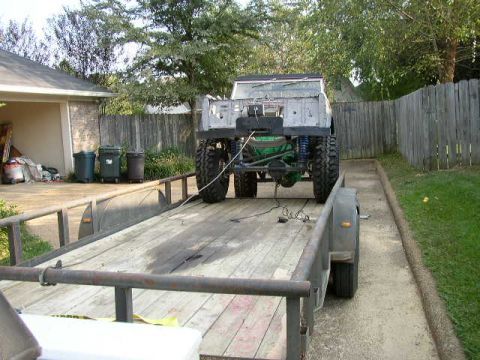1995 Ford Bronco - This off-road vehicle, possibly a Ford Bronco, is seen from the rear while loaded onto a trailer.