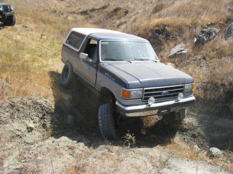 1989 Ford Bronco - This Ford Bronco navigates a steep, rutted dirt path on an off-road excursion.