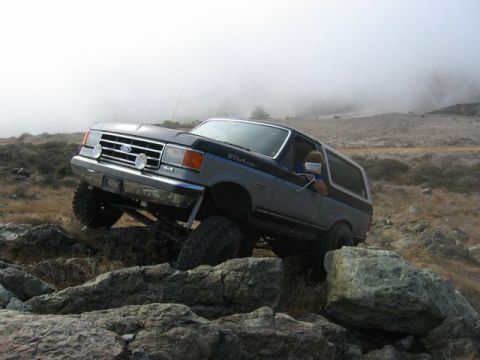 1989 Ford Bronco - Ford Bronco navigates rocky terrain during an off-road excursion.
