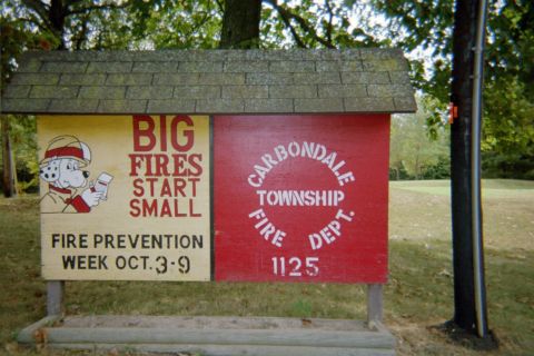 1998 Ford Crown Victoria - Sign for Fire Prevention Week and Carbondale Township Fire Dept. is displayed outdoors.