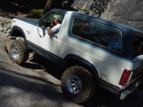 1986 Ford Bronco - Ford Bronco navigates a challenging rocky trail during an off-road excursion.