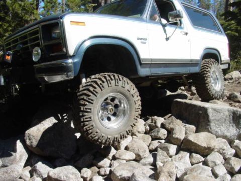 1986 Ford Bronco - Ford Bronco tackles a challenging rocky terrain during an off-road excursion.