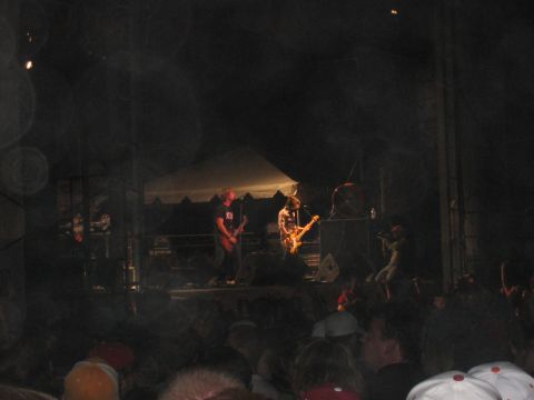 1988 Ford Bronco - A band performs live on stage at an outdoor concert venue.