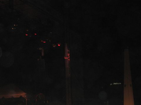1988 Ford Bronco - A dark concert scene is captured with stage lighting and a tall structure, along with visible website text.
