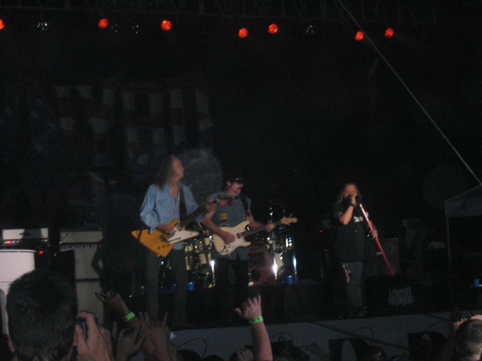 Band performing on stage with guitars and drums