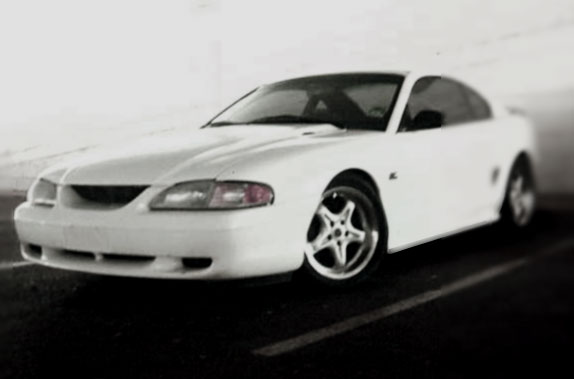 White coupe with a five-spoke wheel, seen from the front-left
