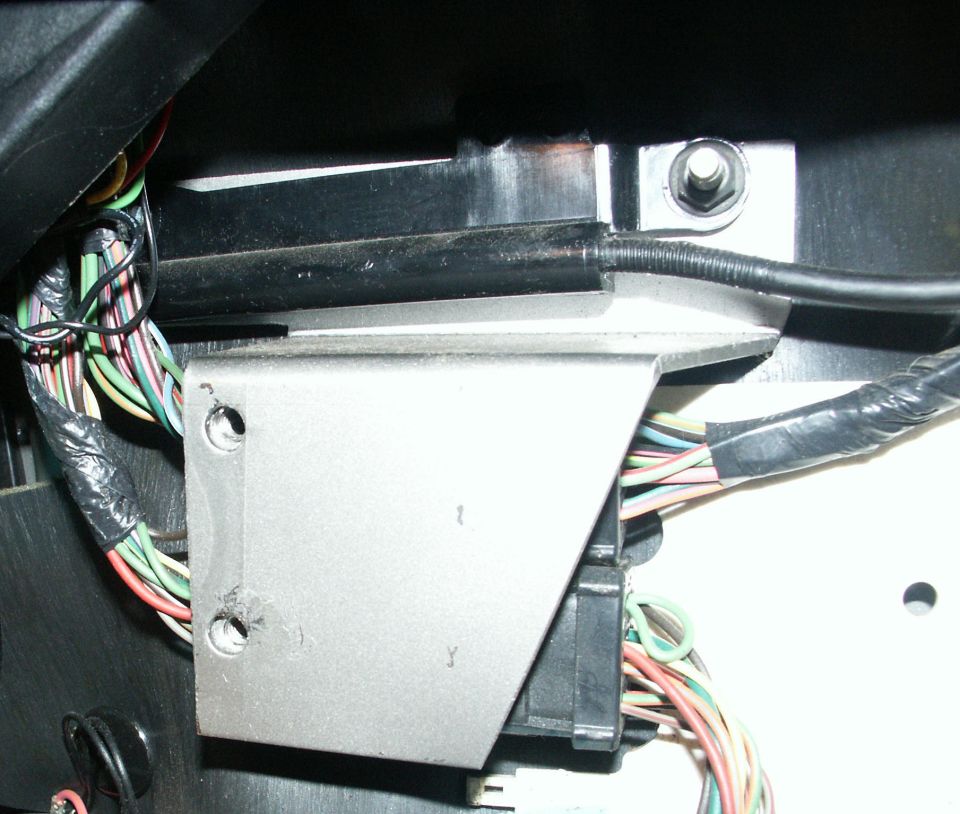 Vehicle interior wiring harness and bracket behind dashboard