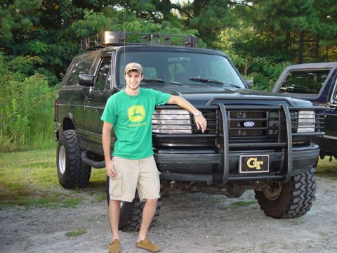 1989 Ford Bronco - A man poses with a lifted Ford Bronco, which appears to be from the early 1990s, not 1989.