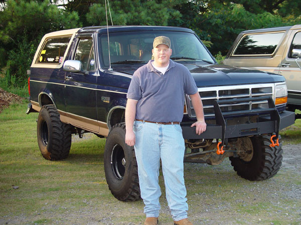 Blue 1989 Ford Bronco with tan top and aftermarket bumper