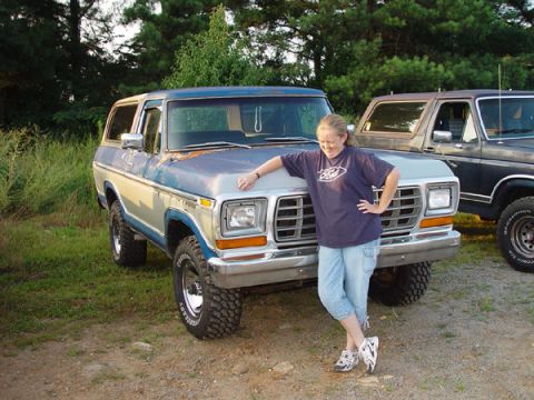 1989 Ford Bronco - A woman poses with a weathered 1978 Ford Bronco, with another truck visible behind it.