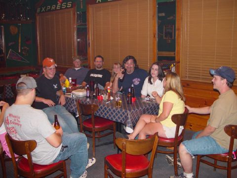 1989 Ford Bronco - A group of friends enjoys a gathering around a table, with drinks and conversation filling the room.