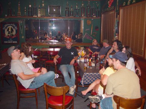 1989 Ford Bronco - A group of friends enjoy drinks and conversation in a bar setting.