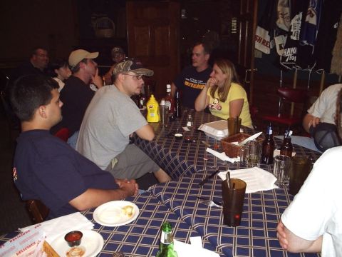 1989 Ford Bronco - A group of individuals are seated around a table, engaged in conversation and enjoying refreshments.