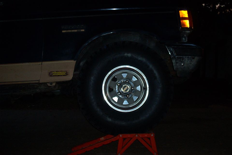 front right tire on ramp, still inches away from body (dark again)