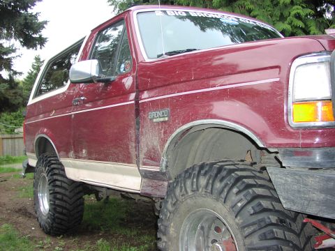 1993 Ford Bronco - This lifted Ford Bronco has aggressive off-road tires and a custom sticker on the windshield.