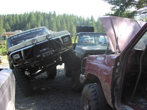 1993 Ford Bronco - Several modified trucks, including a 1978 Ford Bronco, are parked together outdoors.