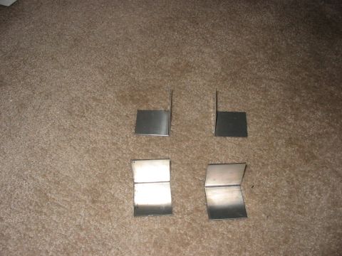 1988 Ford Bronco - Four metal brackets are shown on a carpeted surface, with a Supermotors.net watermark in the lower right corner.