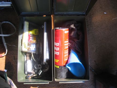 1988 Ford Bronco - Contents of storage boxes, including fuses, cleaner, and a funnel, are visible.