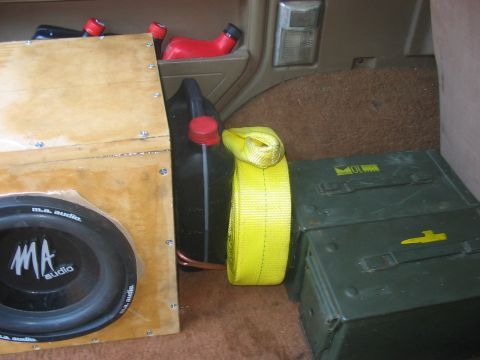 1988 Ford Bronco - Custom speaker box and storage containers fill the cargo area of a vehicle.