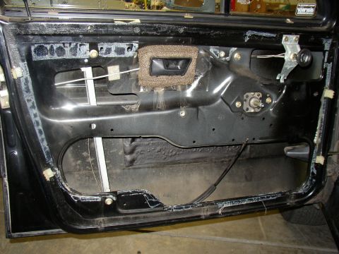1987 Volkswagen Golf - Interior view of a car door, showing the window mechanism and door panel structure.