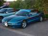 1994 Ford Probe - A blue 1994 Ford Probe is parked next to another vehicle.