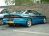 1994 Ford Probe - Rear view of a blue 1994 Ford Probe, parked in a lot next to another car.