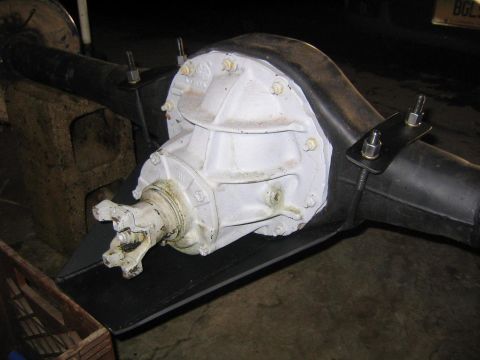 1978 Ford Bronco - A white differential housing is shown mounted on black axle tubes, secured by U-bolts.