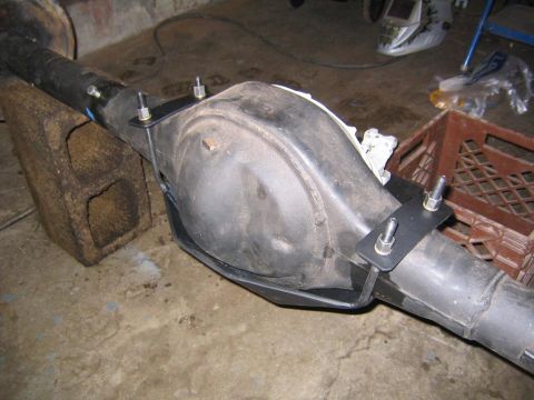 1978 Ford Bronco - A rear differential assembly with a skid plate is shown, supported by cinder blocks in a workshop.