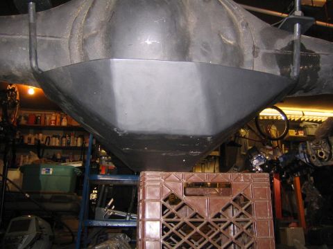 1978 Ford Bronco - Close-up of a vehicle's differential housing and skid plate, with a crate below.