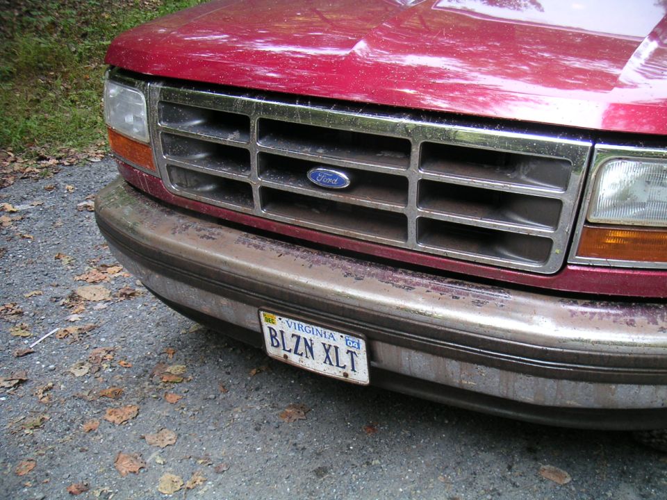 Red 1994 Ford Bronco front grille with Ford logo and Virginia license plate BLZN XLT