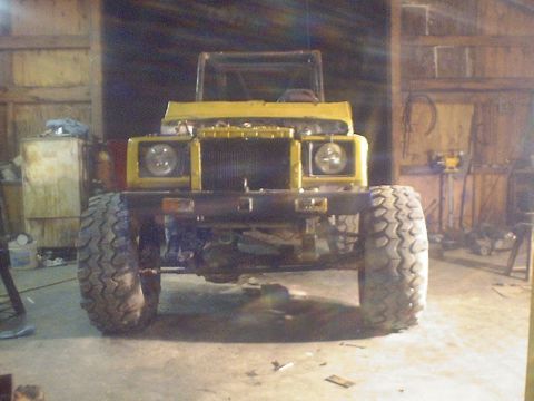 1989 Ford Bronco - This modified Suzuki Samurai sits in a garage, ready for off-road adventures.