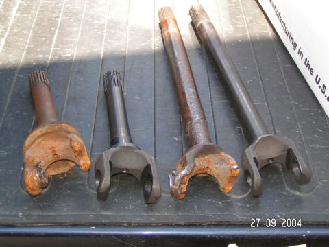 1978 Ford Bronco - Collection of drive shafts, showing varying degrees of wear and rust.