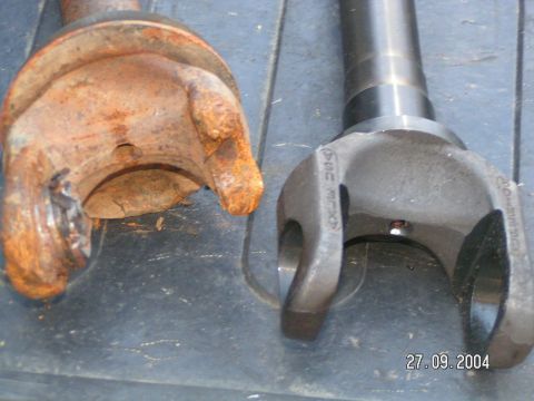 1978 Ford Bronco - Comparison of a heavily corroded driveshaft U-joint with a new replacement part.