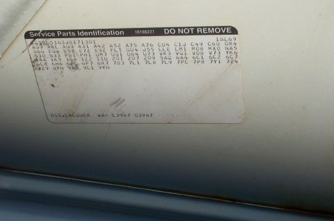 1995 Ford Crown Victoria - A sticker with codes and text is affixed to the interior of a vehicle's door jamb.