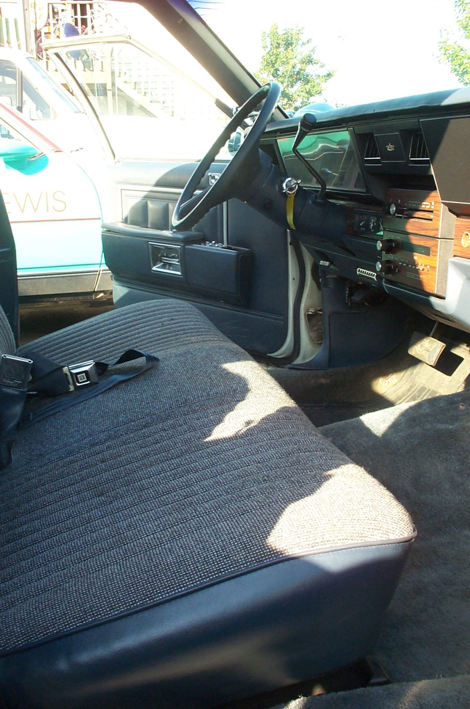 Interior view of a car with patterned seats and dashboard