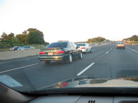 1993 Ford Taurus - Multiple vehicles on a highway during the day.