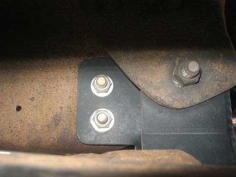 1988 Ford Bronco - This image shows a close-up view of a lift kit bracket attached to the vehicle's frame.